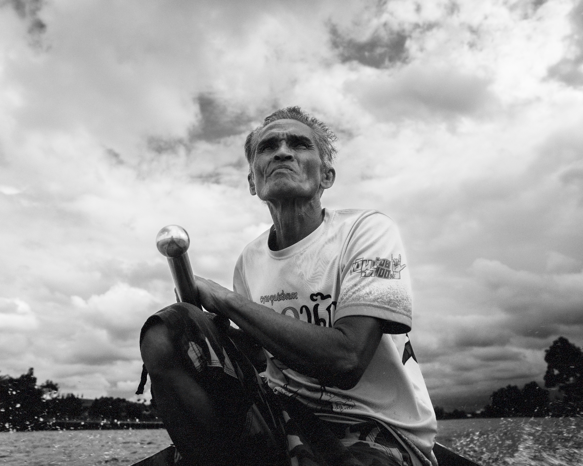 Black and white portrait of an older racer at the tiller