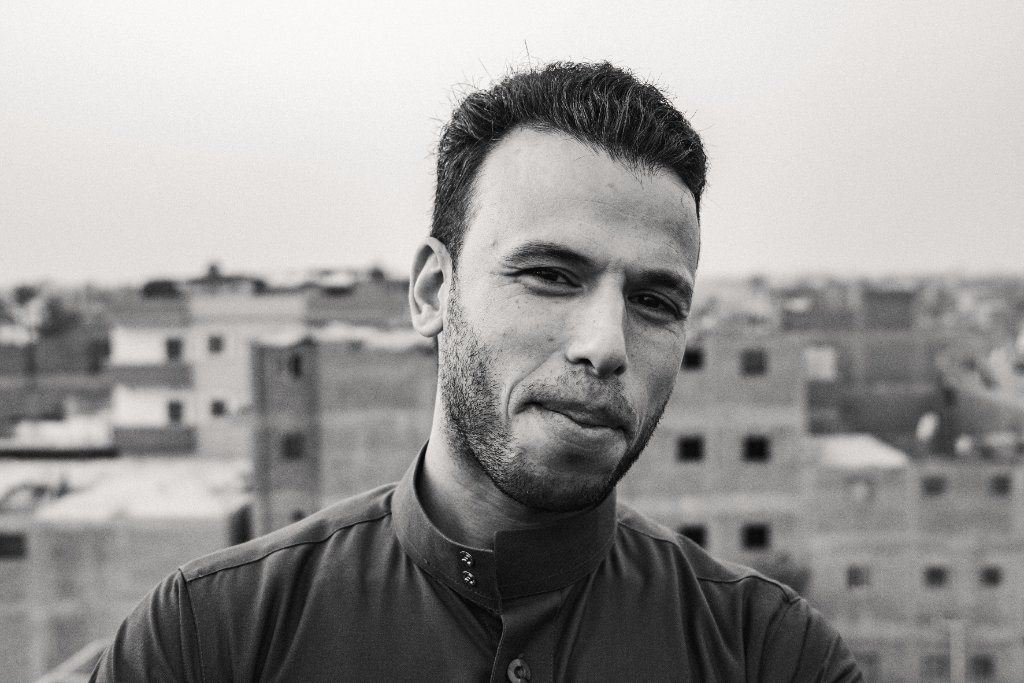 Black and white portrait of a young man on a Cairo rooftop